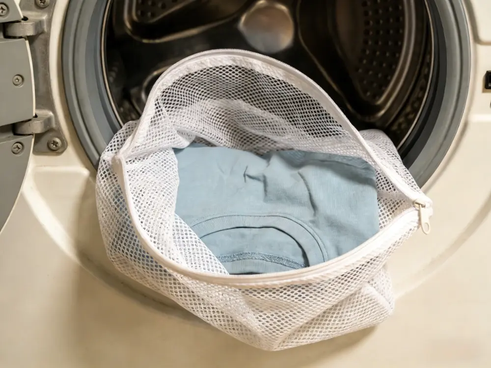 Using a mesh laundry bag to wash delicate 100% cotton clothing.
