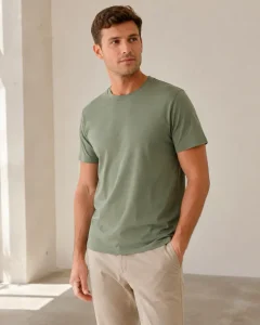 Model wearing a sage green crew-neck T-shirt with a close round neckline