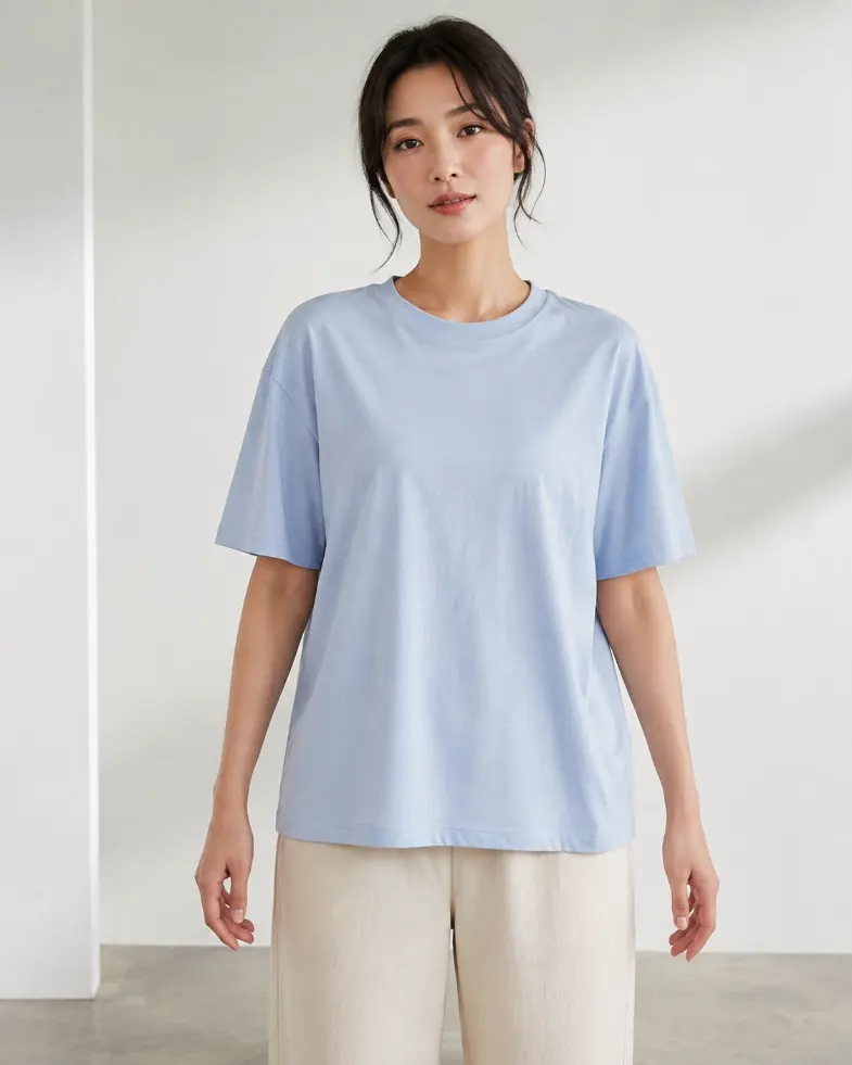 Model wearing a pale blue relaxed-fit T-shirt with extra ease and soft drape